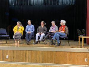 Photo of the Skagit County Library Directors and Acting Directors sitting on chairs on an auditorium stage.