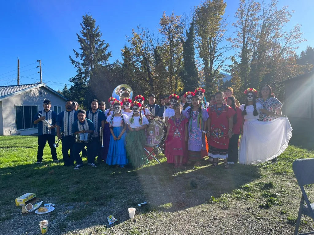 This image shows the band and girls dressed as dancers in honor for the Day of the Dead.