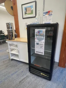 This image shows a empty fridge in the library.